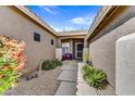 Inviting front porch with a cozy bench, desert plants, and a stone walkway at 5537 E Dusty Wren Dr, Cave Creek, AZ 85331