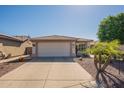 Inviting home showcasing a manicured lawn, desert foliage, tile roof and a convenient two-car garage at 6397 S Pinaleno Pl, Chandler, AZ 85249