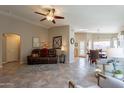 Open-concept living area with tile flooring, ceiling fan, and comfortable seating arrangements at 6397 S Pinaleno Pl, Chandler, AZ 85249