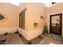 Charming courtyard with custom paint, mature landscaping, and a tiled roof at 6526 N 13Th Dr, Phoenix, AZ 85013