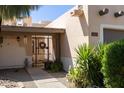 Home entry, with gated courtyard and front door, desert landscaping, and exterior lighting at 6526 N 13Th Dr, Phoenix, AZ 85013