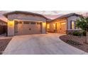 Spacious three car garage with a wide driveway and meticulously landscaped yard at 7234 S 28Th Ln, Phoenix, AZ 85041