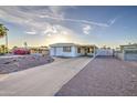 Inviting single-story home featuring a well-maintained driveway and desert landscaping at 7318 E Arbor Ave, Mesa, AZ 85208