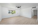 Bright living room features neutral walls, modern ceiling fan, and luxury vinyl plank flooring at 843 N Evergreen St, Chandler, AZ 85225