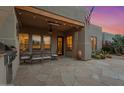 Outdoor patio with BBQ, seating area, and view of desert landscaping at 9566 E Raindance Trl, Scottsdale, AZ 85262