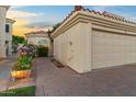 Charming home exterior showing a two-car garage, brick walkway, and beautiful landscaping at 1700 E Lakeside Dr # 12, Gilbert, AZ 85234