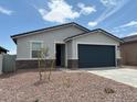 Charming single-story home features a two-car garage and low maintenance front yard at 17425 W Eva St, Waddell, AZ 85355