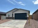 Charming single-story home features a two-car garage and low maintenance front yard at 17425 W Eva St, Waddell, AZ 85355