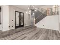 Elegant entryway featuring hardwood floors, an ornate staircase, and modern lighting fixtures at 2018 W Whisper Rock Trl, Phoenix, AZ 85085