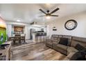 Inviting living room featuring modern ceiling fan and open layout to kitchen with breakfast bar at 3535 W Tierra Buena Ln # 256, Phoenix, AZ 85053