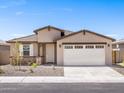 Inviting single-story home featuring a two-car garage, desert landscaping, and a covered front porch at 37373 W San Clemente St, Maricopa, AZ 85138
