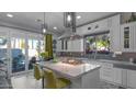 Modern kitchen featuring a marble island, white cabinetry, and stainless steel appliances at 3956 S Hollyhock Pl, Chandler, AZ 85248