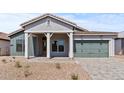 Inviting single-story home with desert landscaping, covered entry and stone driveway leading to a two-car garage at 42064 N Golden Trl, San Tan Valley, AZ 85140