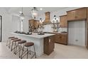 Spacious kitchen with large island, pendant lighting, stainless appliances, and stylish countertops at 42064 N Golden Trl, San Tan Valley, AZ 85140