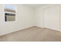 Clean bedroom with carpet floors, a window, and a closet for ample storage at 4347 W Hannah St, San Tan Valley, AZ 85144