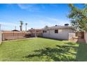 Spacious backyard featuring a well manicured lawn and privacy fence at 6714 N 26Th Dr, Phoenix, AZ 85017