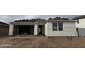 Exterior view of home in progress featuring garage, front entry, and stacked roof tiles at 7736 W Coyote Dr, Peoria, AZ 85383