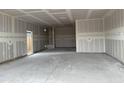 Spacious garage with a neutral interior awaits customization, offering ample room for vehicles and storage at 7736 W Coyote Dr, Peoria, AZ 85383