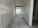 A long hallway with finished walls, leading to the rest of the property at 7736 W Coyote Dr, Peoria, AZ 85383