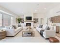 Bright living room with a modern fireplace, built-in shelves, and neutral-toned furniture at 9802 N 77Th St, Scottsdale, AZ 85258