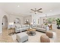 Open-concept living space features neutral decor, ceiling fan and an adjacent dining area at 9802 N 77Th St, Scottsdale, AZ 85258