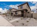 Modern two-story home featuring stone accents and a gravel front yard, adding curb appeal at 15587 S 180Th Ln, Goodyear, AZ 85338