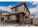 Stylish exterior showcasing stucco, stone accents, and a low-maintenance gravel front yard design at 15587 S 180Th Ln, Goodyear, AZ 85338