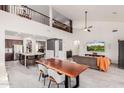 Open-concept living area with high ceilings, modern furnishings, and a large kitchen island at 31069 N 138Th Ave, Peoria, AZ 85383