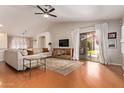 Open living room featuring hardwood floors, lots of seating, and a view of the backyard at 6061 E Rochelle St, Mesa, AZ 85215