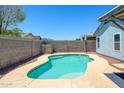 Inviting backyard pool surrounded by concrete decking and privacy walls, perfect for outdoor enjoyment at 11501 W Charter Oak Rd, El Mirage, AZ 85335