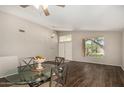 Light and bright dining area features wood flooring and a stylish glass table with seating for four at 1631 E Carla Vista Dr, Chandler, AZ 85225