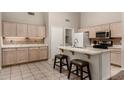 Bright open kitchen features an eat-in island with granite countertops and barstool seating at 1631 E Carla Vista Dr, Chandler, AZ 85225