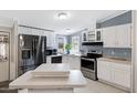 Kitchen with white cabinets, stainless steel appliances, and great lighting at 201 S Greenfield Rd # 51, Mesa, AZ 85206