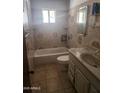 Functional bathroom features a sink vanity, toilet, and a bathtub with tile surround at 3820 W Encanto Blvd, Phoenix, AZ 85009