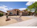 Attractive single-story house with desert landscaping and a spacious two car garage at 4529 E Thistle Landing Dr, Phoenix, AZ 85044