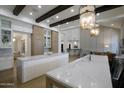 Bright open kitchen featuring double islands, marble counters, and ample cabinetry with seamless flow to the living area at 6718 E Caron Dr, Paradise Valley, AZ 85253