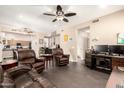 Spacious living room featuring comfortable leather seating and modern entertainment setup, bathed in natural light at 9646 N 94Th Ave, Peoria, AZ 85345