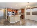 Open kitchen with stainless steel appliances, granite countertops, and a large island at 12217 W Planada Ln, Sun City, AZ 85373
