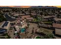 Spacious backyard with a sparkling pool, covered patio, lush landscaping, and solar panels that make the property eco-friendly at 12745 W Monte Vista Rd, Avondale, AZ 85392