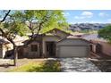 Charming single-story home with desert landscaping, two-car garage, and mountain views at 2021 E Caldwell St, Phoenix, AZ 85042