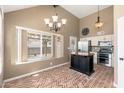 Bright kitchen with stainless steel appliances, breakfast bar, and brick flooring and large window at 20818 N 21St Dr, Phoenix, AZ 85027