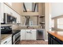 Updated kitchen featuring stainless appliances, granite countertops, and eat-in breakfast bar at 20818 N 21St Dr, Phoenix, AZ 85027