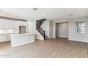An open kitchen and dining area with an island, modern appliances, and a staircase at 5852 E Covey Ln, Phoenix, AZ 85054