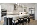Modern kitchen boasts a large island, barstool seating, and stainless steel appliances at 5931 E Sierra Morena St, Mesa, AZ 85215