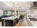 Elegant kitchen with a center island, modern appliances, and an open layout connecting to the living room at 5931 E Sierra Morena St, Mesa, AZ 85215