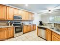 Well-equipped kitchen with stainless steel appliances, granite countertops, and wood cabinetry at 11259 W Locust Ln, Avondale, AZ 85323