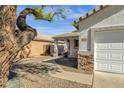 Inviting single-story home featuring stone accents and a covered porch, enhanced by desert landscaping at 1320 E Binner Dr, Chandler, AZ 85225
