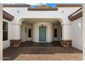 Inviting covered entryway featuring stone accents, archways, and a teal-colored front door at 14112 N 12Th St, Phoenix, AZ 85022