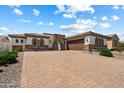 Spacious home featuring desert landscaping, a paver driveway, and a three-car garage with custom doors at 14112 N 12Th St, Phoenix, AZ 85022