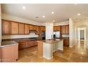 Bright kitchen boasts custom cabinets, granite countertops, stainless steel appliances, and tile floors at 14112 N 12Th St, Phoenix, AZ 85022